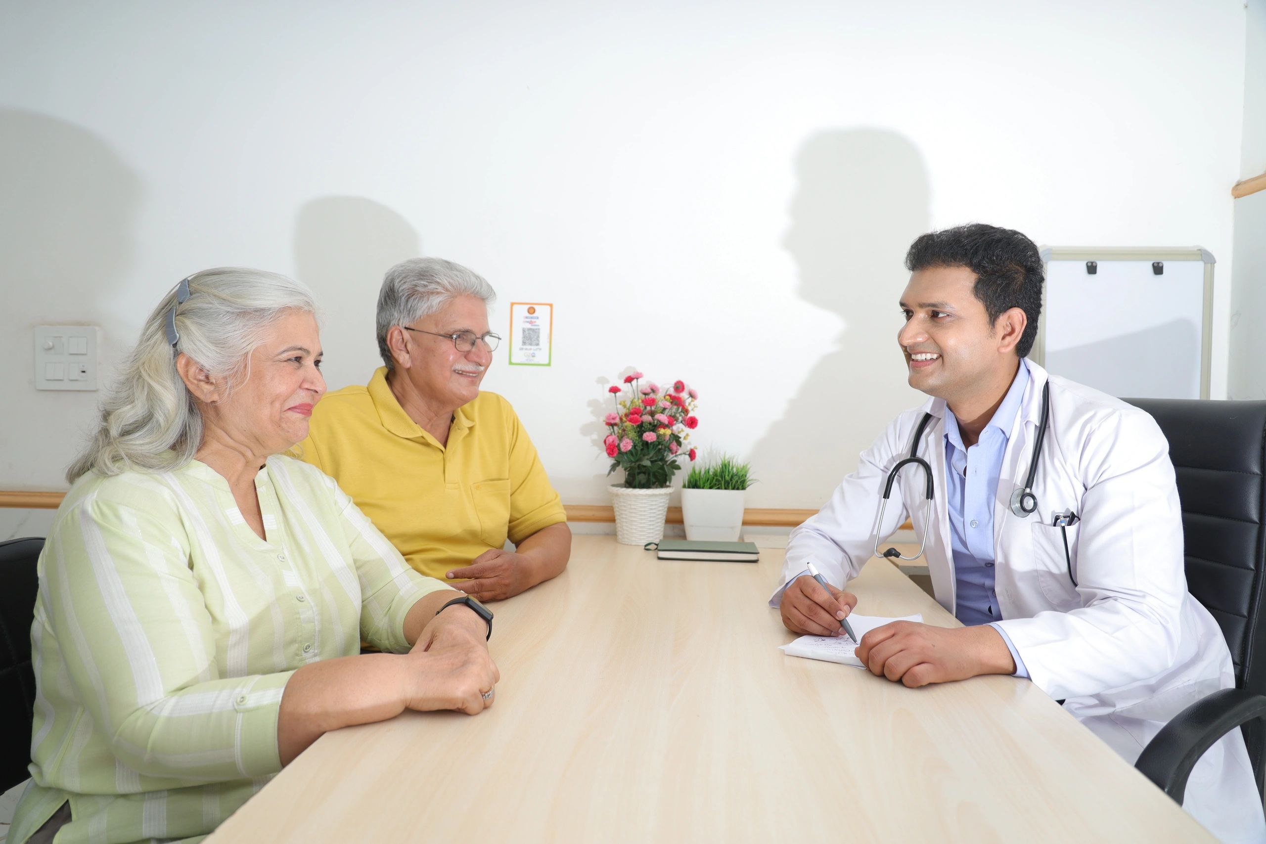 Doctor speaking with elderly patients during a consultation