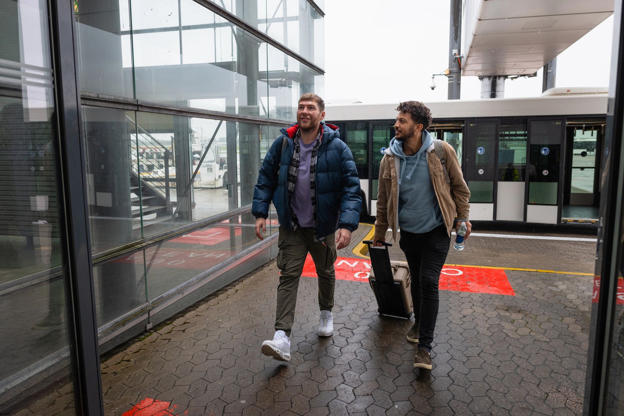 Travelers arriving at an airport shuttle