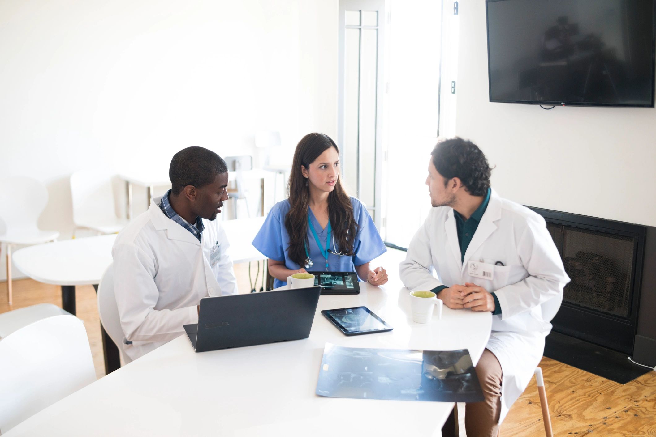 Doctors collaborating with tablets and scans